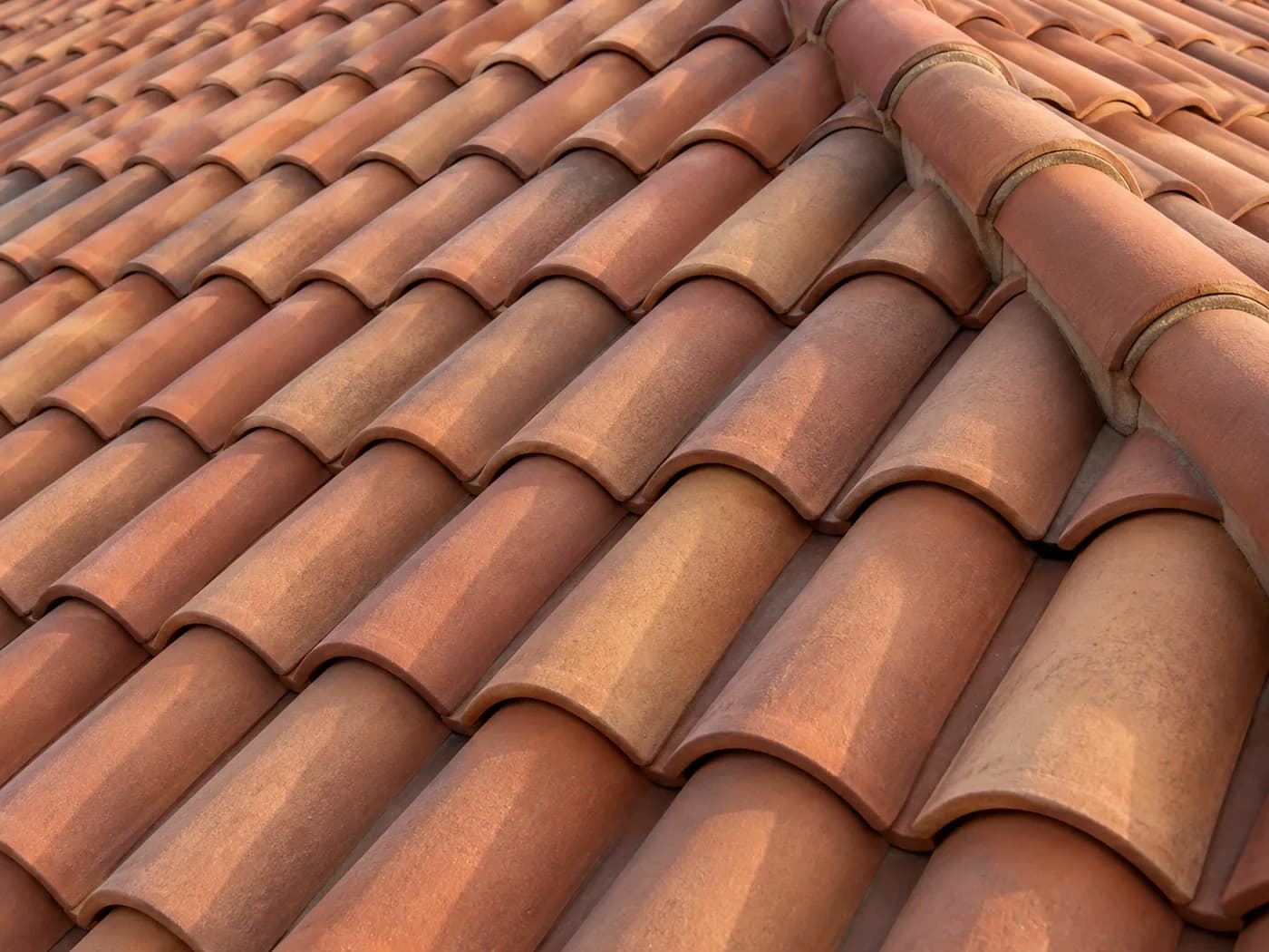 Close-up of overlapping terracotta roof tiles